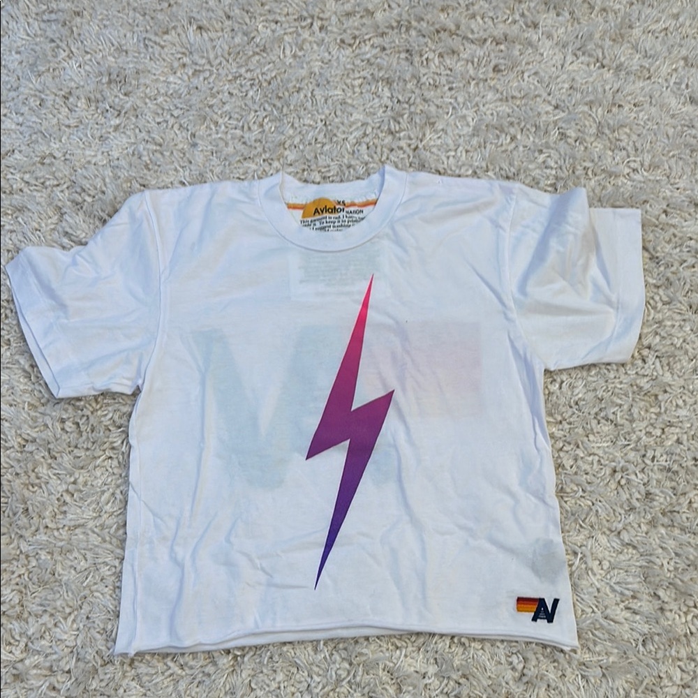 Aviator Nation White Shirt with Purple Lightning Bolt.